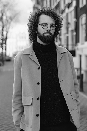Black and white portrait of Dave Kok, UX Designer, standing outdoors in a coat.